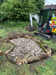 Stone being laid for first layer of the hibernaculum